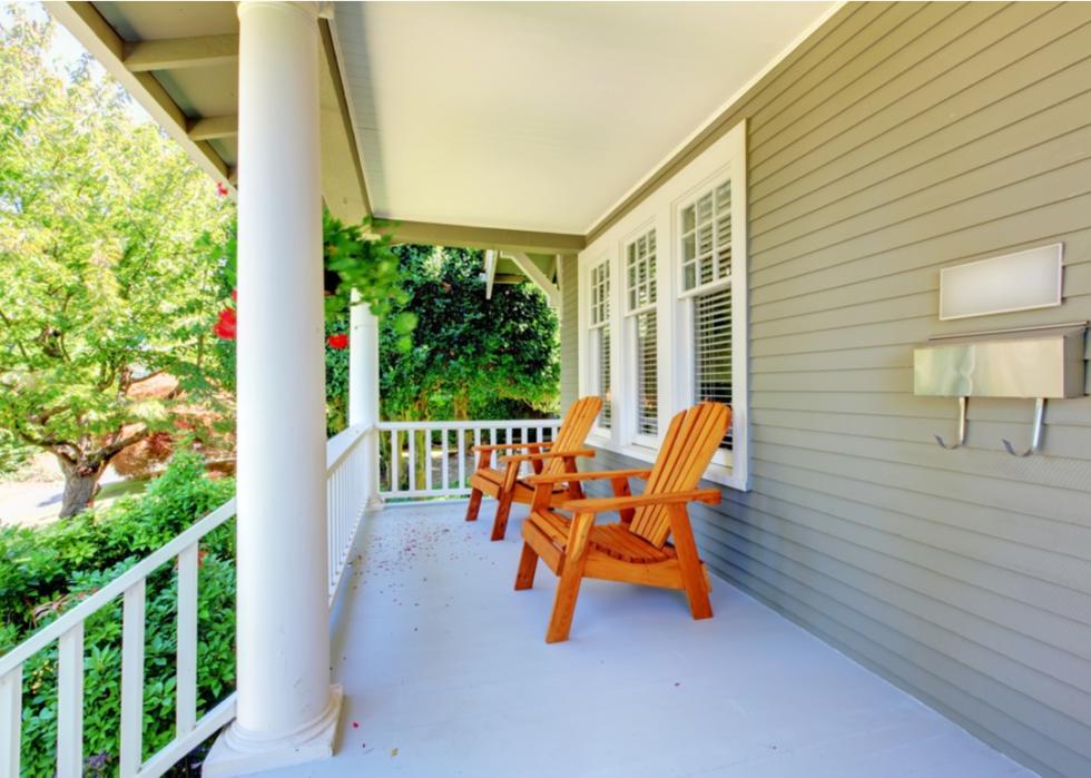 Porch with two Adirondack chairs.