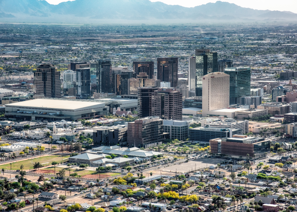 Aerial skyline of Phoenix, Arizona with mountains in the background.