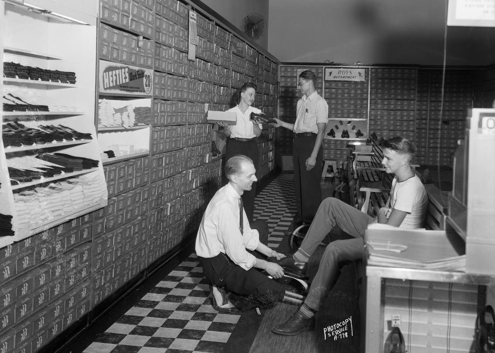 People trying on shoes in a store.