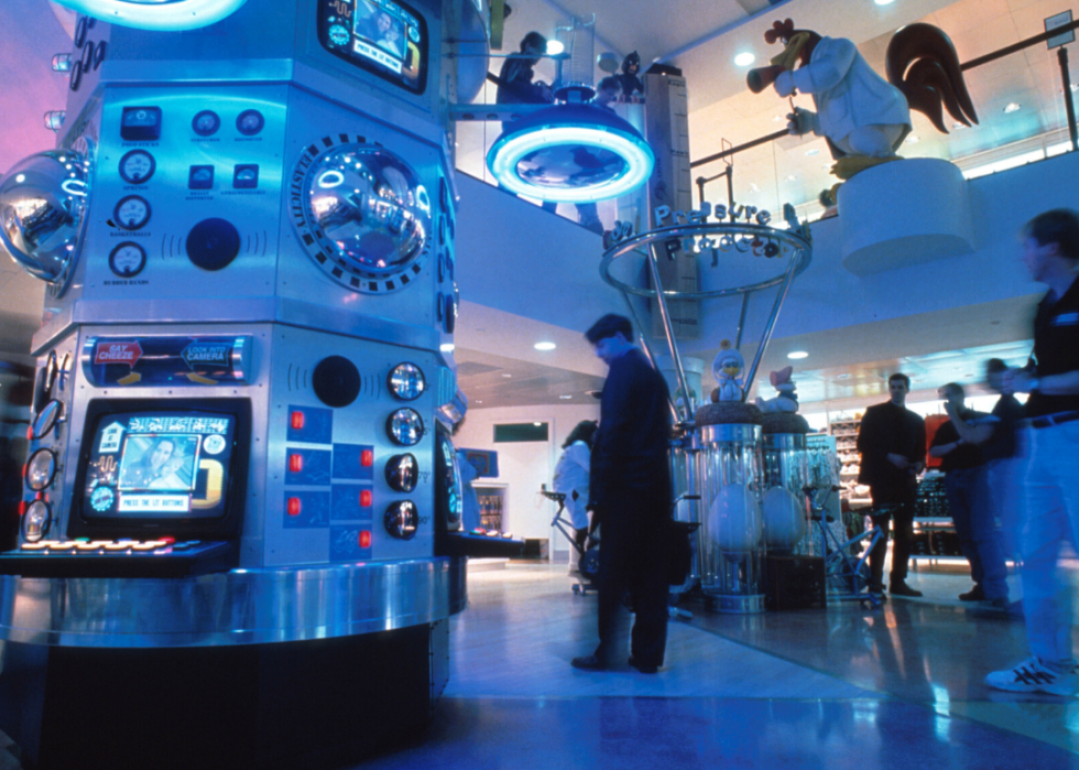 People walking around a Warner Bros. Studio Store under blue lighting.