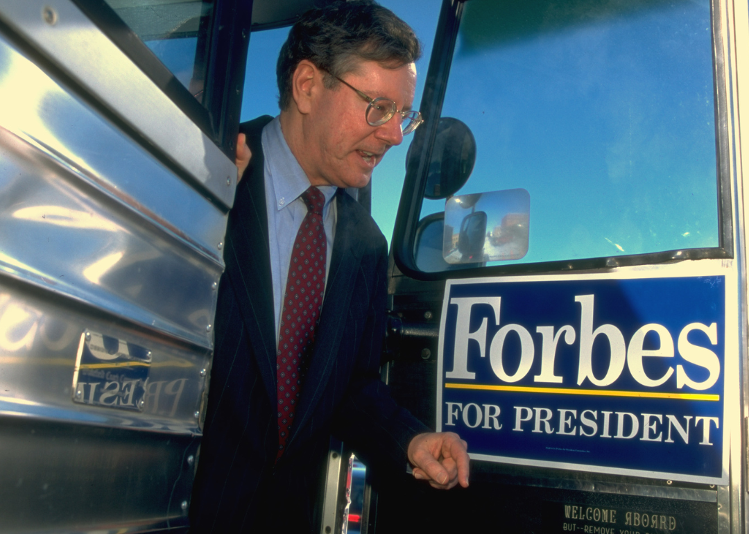Steve Forbes exiting his silver campaign bus.