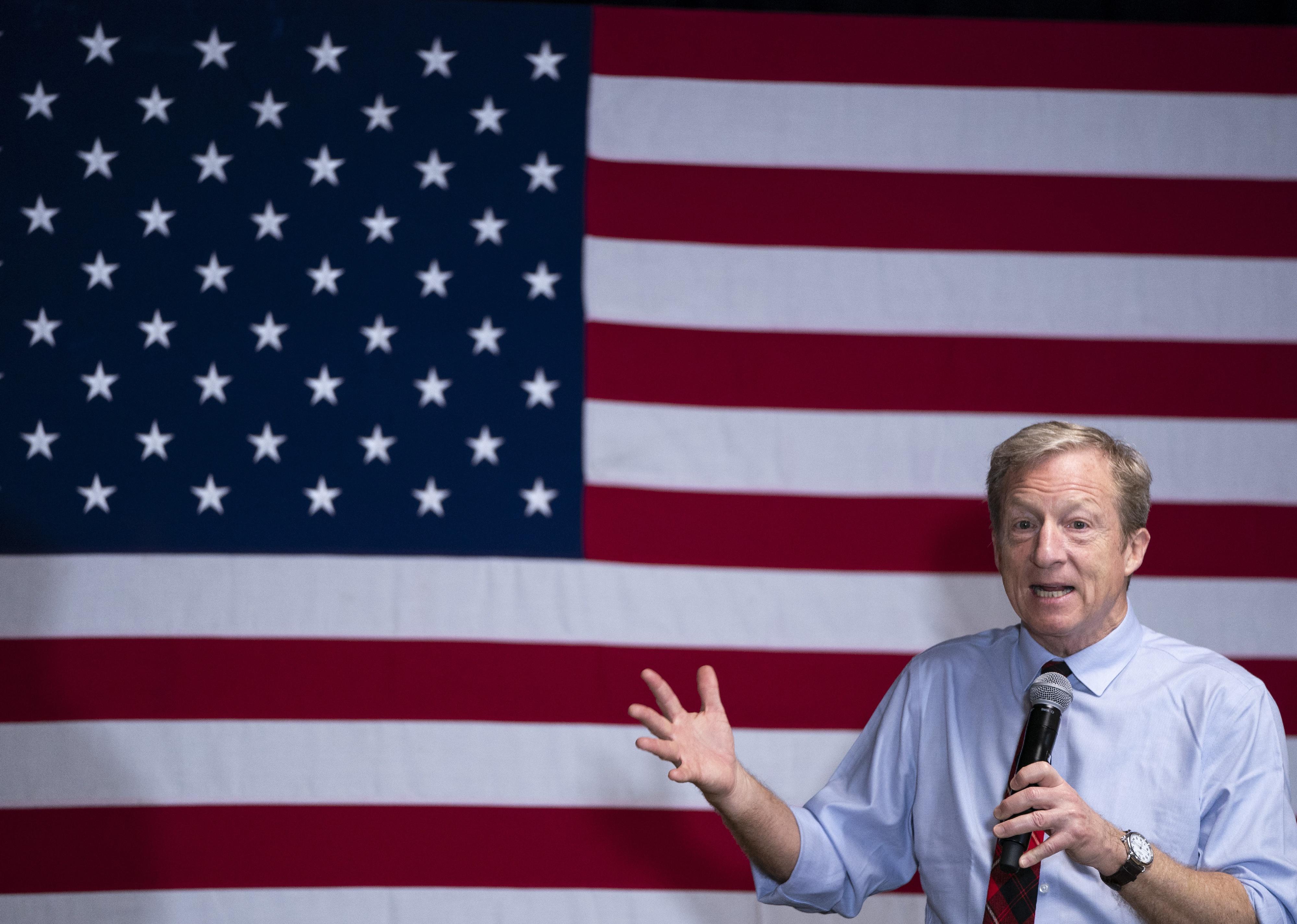 Tom Steyer campaigning in front of an American flag.