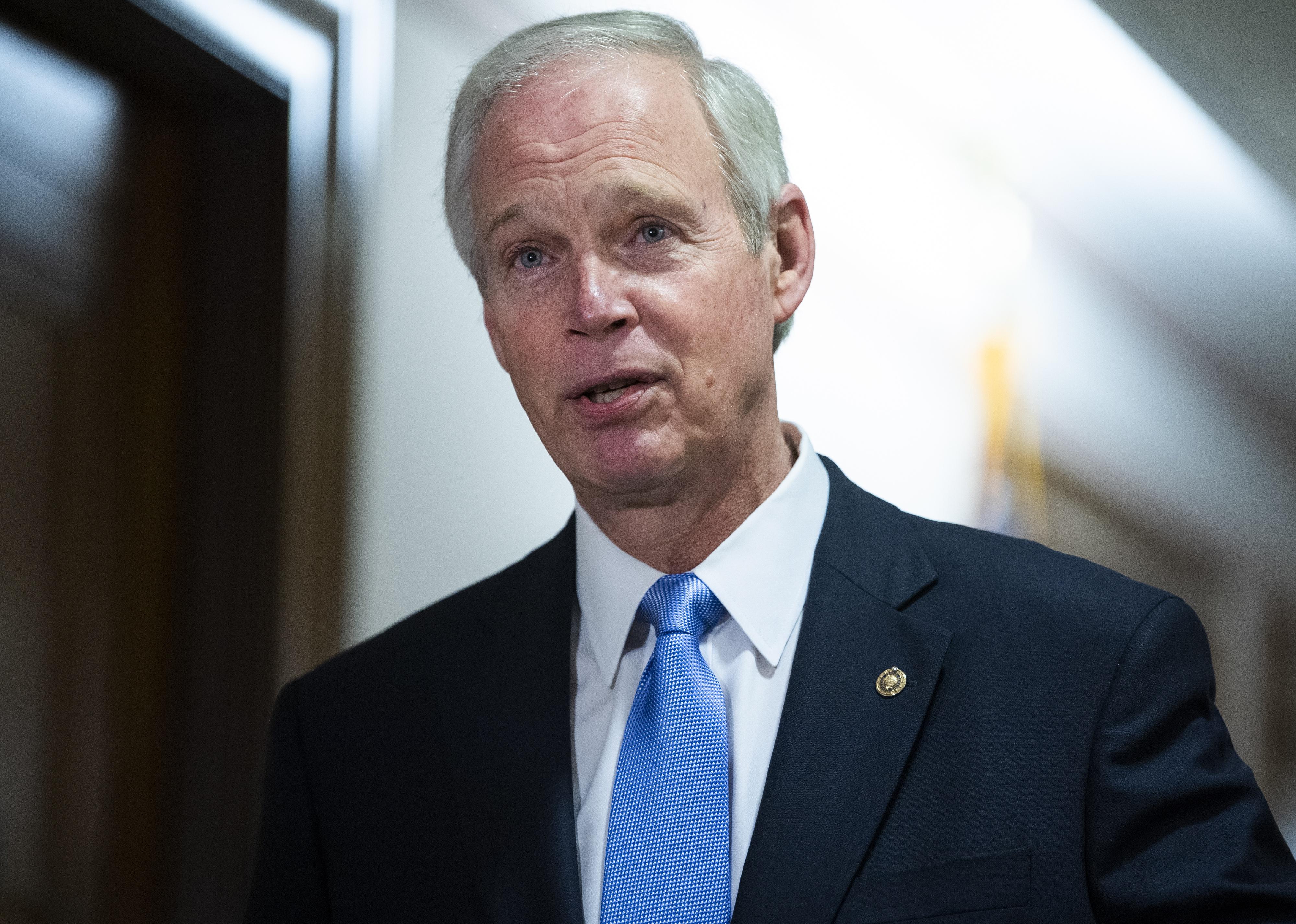 Ron Johnson in a suit and blue tie.