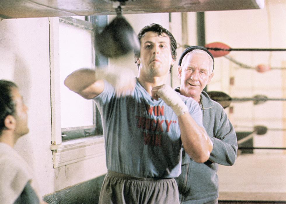 Sylvester Stallone punches a boxing speed bag.