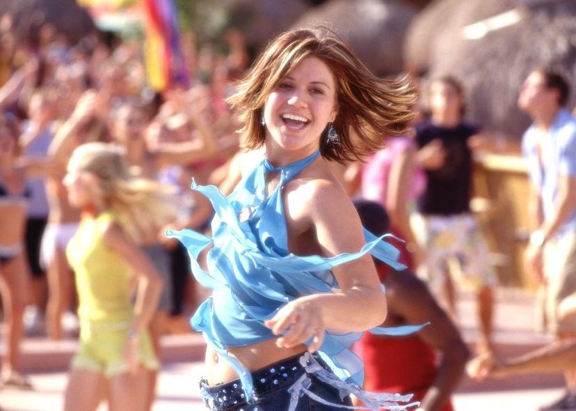 Kelly Clarkson dancing at a party in the sun.