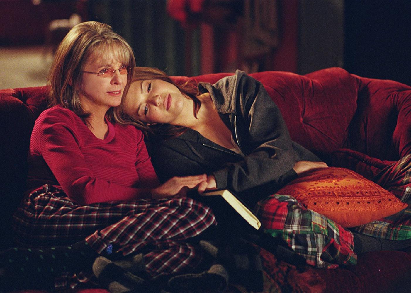 Diane Keaton and Mandy Moore snuggled up on a couch.