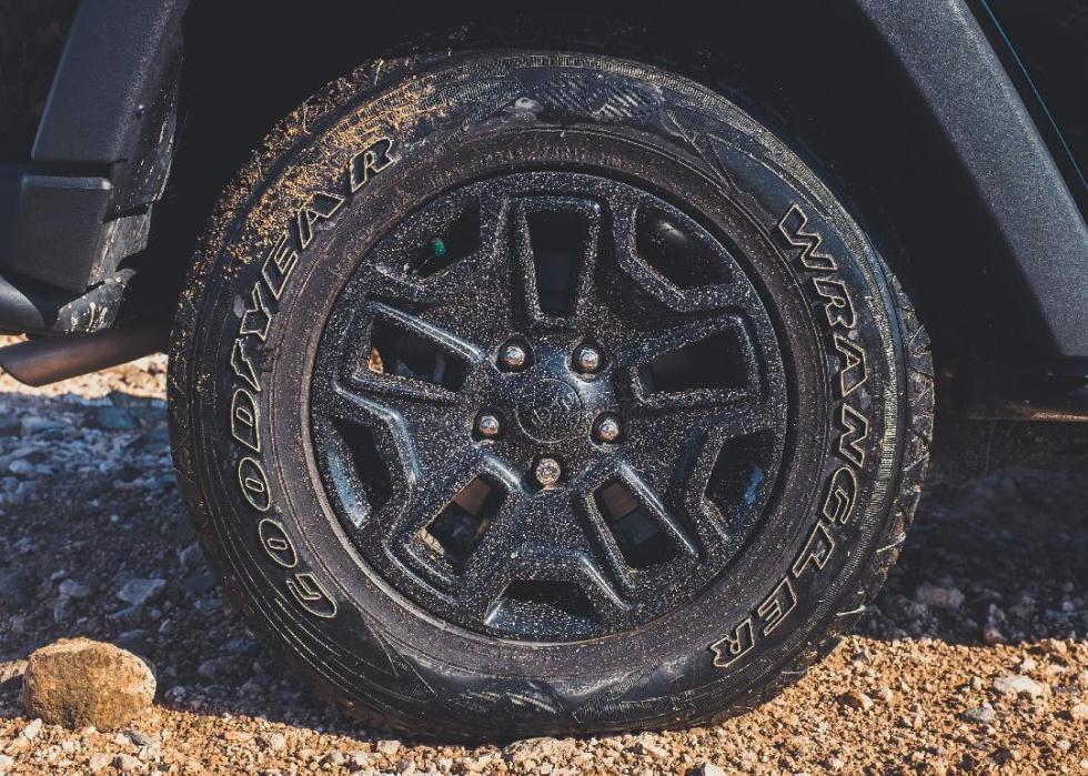 Close-up of dirt-covered Goodyear tire.