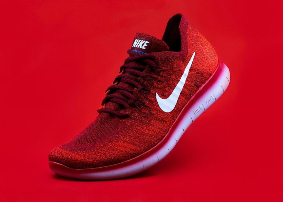 Red Nike shoe positioned to run.