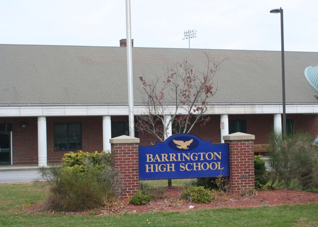 The outside of brick Barrinton school with a blue sign.