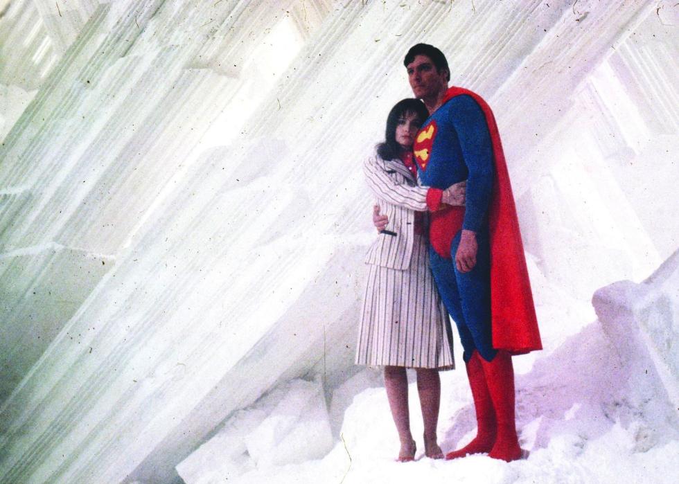 Superman and Lois Lane stand hugging surrounded by all white.