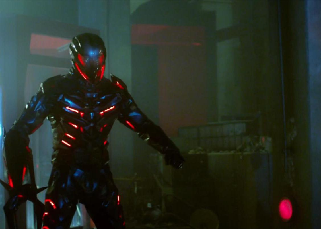 A human / robot figure with metal armor and blue lights.
