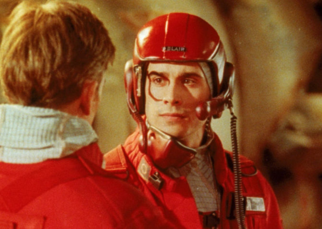 Freddie Prinze Jr. in a red pilot suit and helmet.