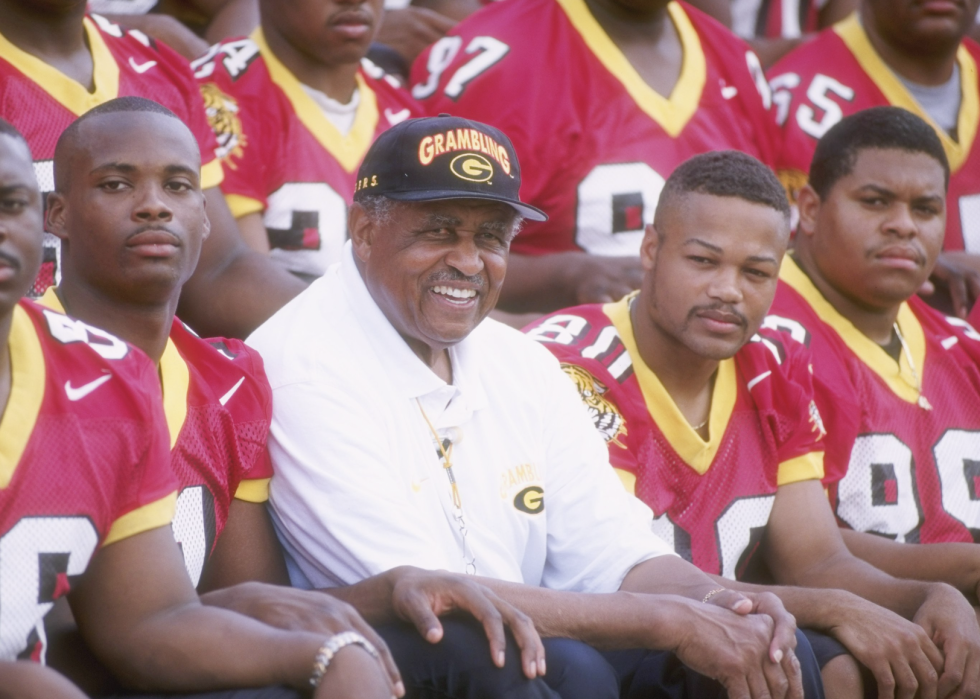 Coach Eddie Robinson of the Grambling State Tigers sits with his team