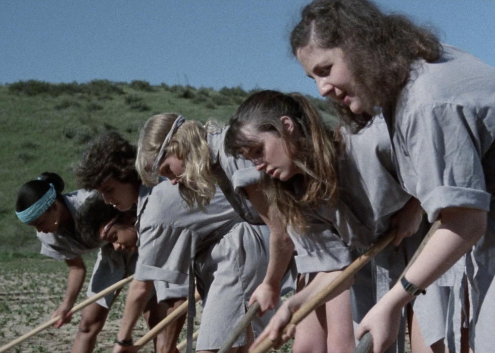 A scene from "Reform School Girls" set in a field