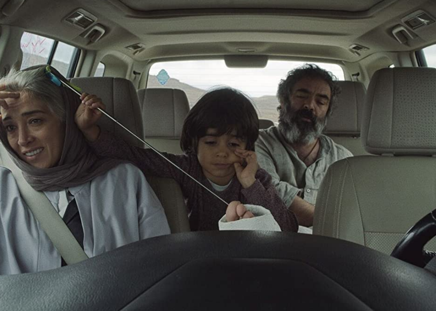 Rayan Sarlak, Mohammad Hassan Madjooni, and Pantea Panahiha in a scene from  "Hit the Road".