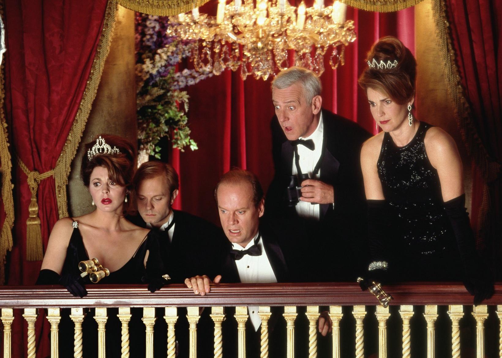 The cast of Frasier on an opera balcony looking down at the stage.