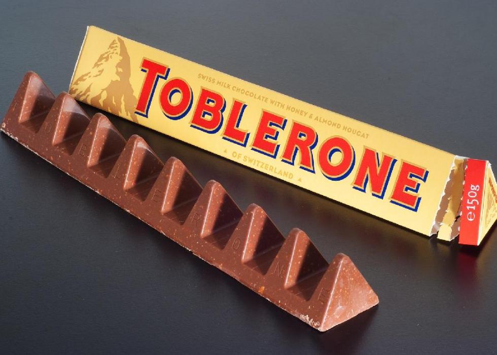 Unwrapped Toblerone candy bar next to its wrapper.
