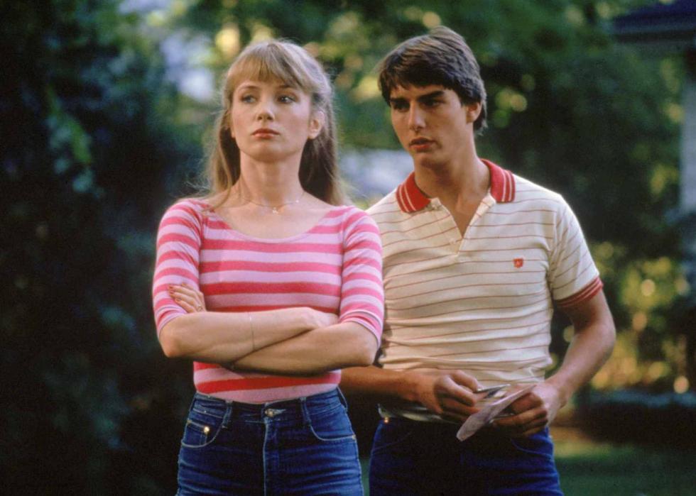 Tom Cruise and Rebecca De Mornay standing together while she looks away.