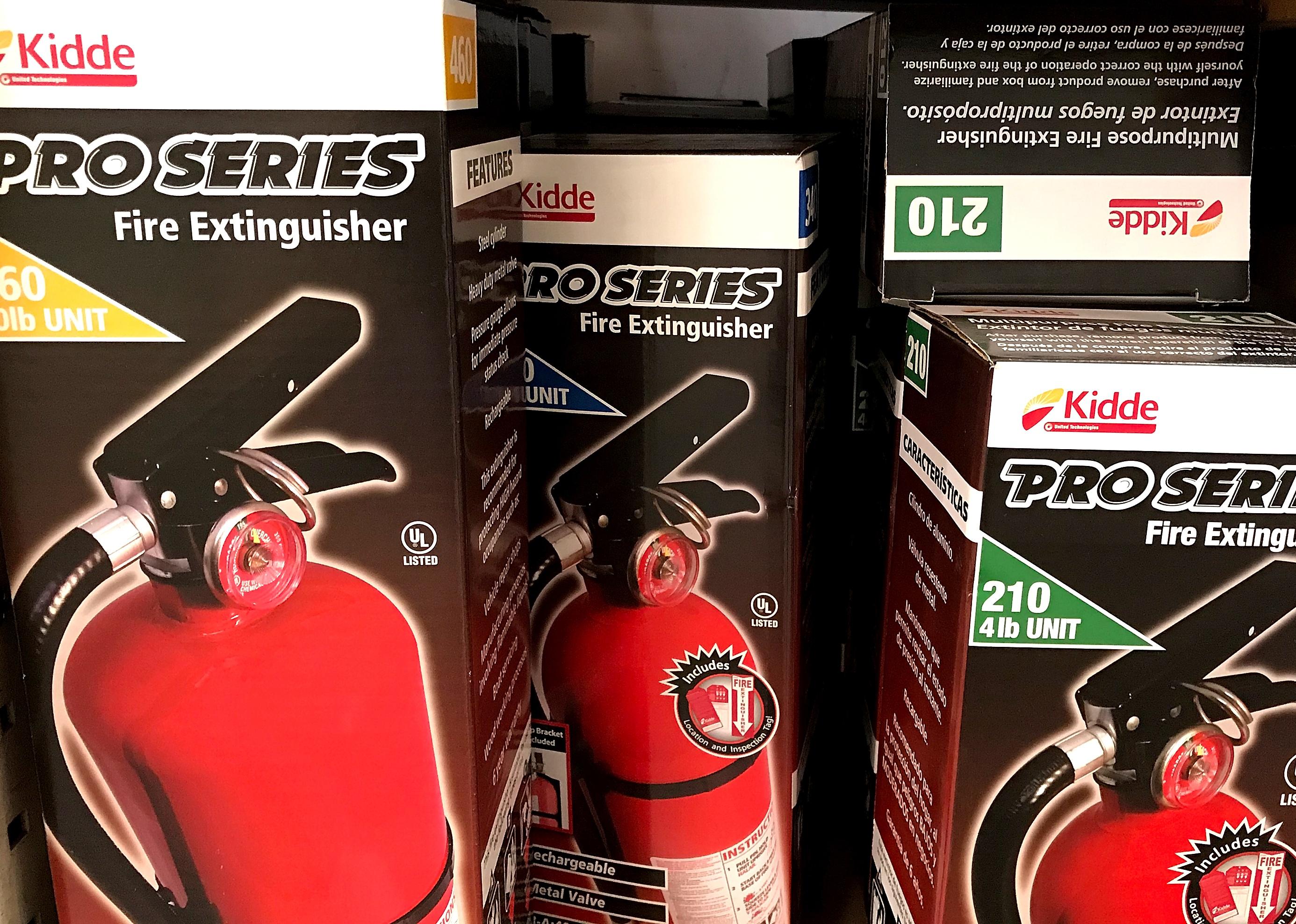 Several boxes of recalled Kidde fire extinguishers.