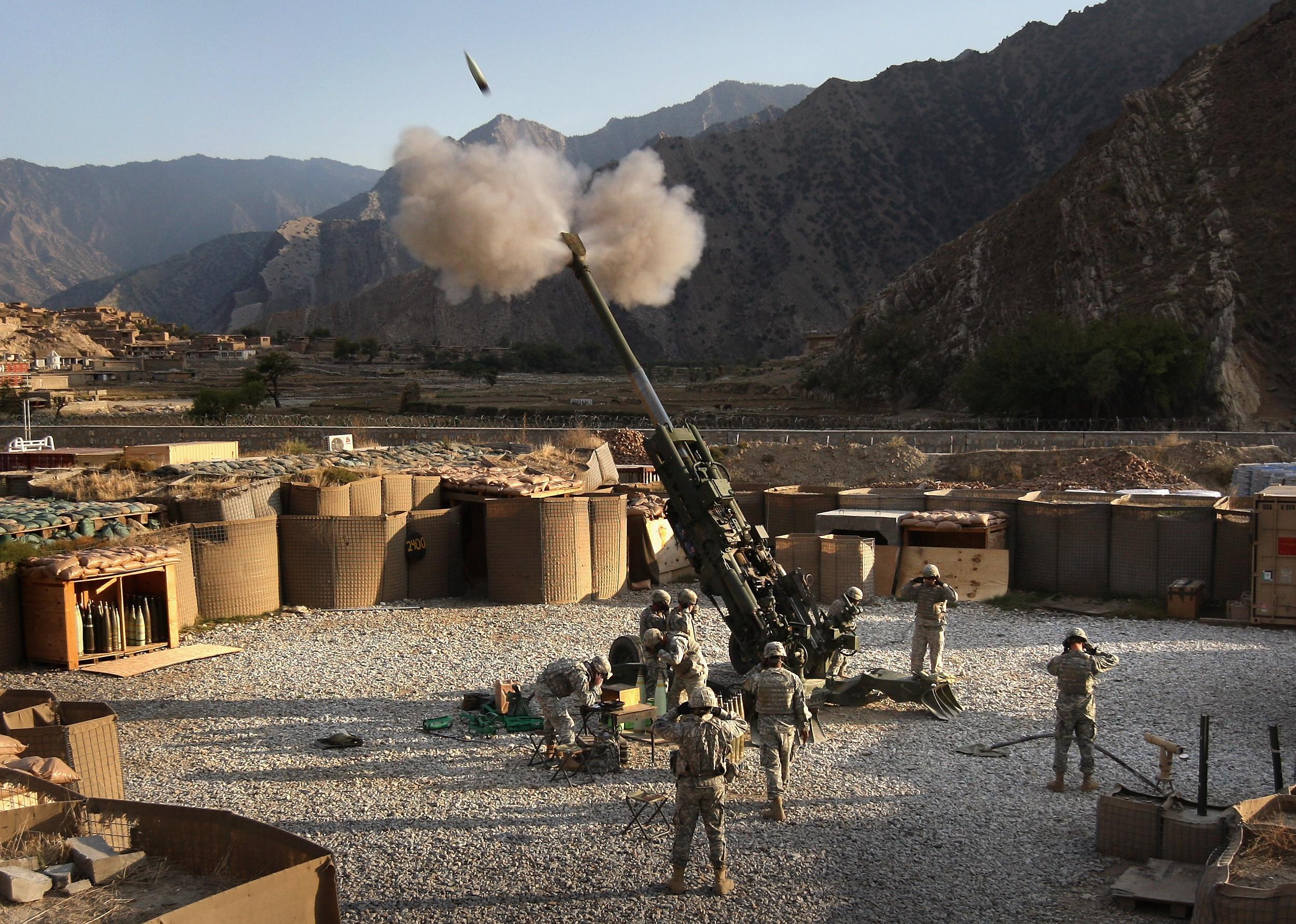 Artillerymen fire a 155mm Howlitzer at a Taliban position in Afghanistan.
