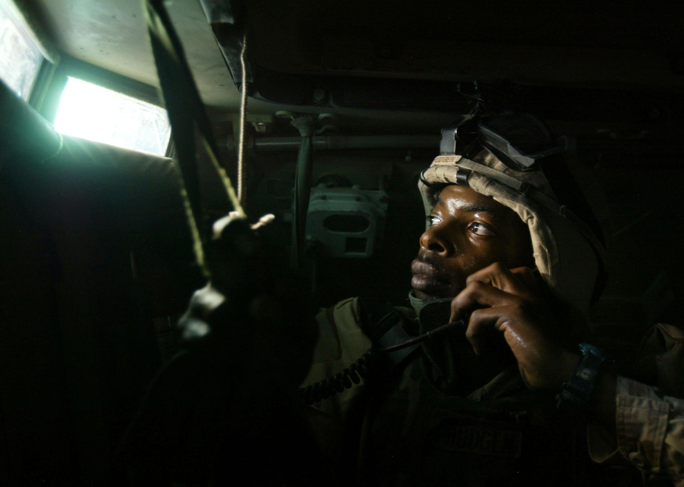 An American Army Sergeant looking out the window of a Bradley fighting vehicle in Najaf, Iraq.