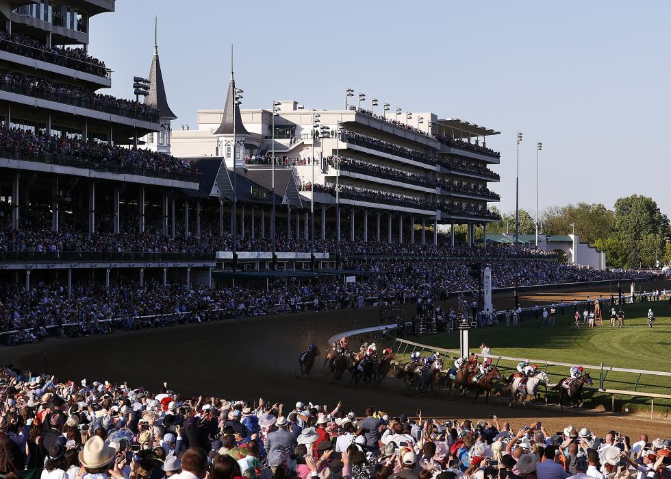 Horses round the first turn during the Kentucky Derby