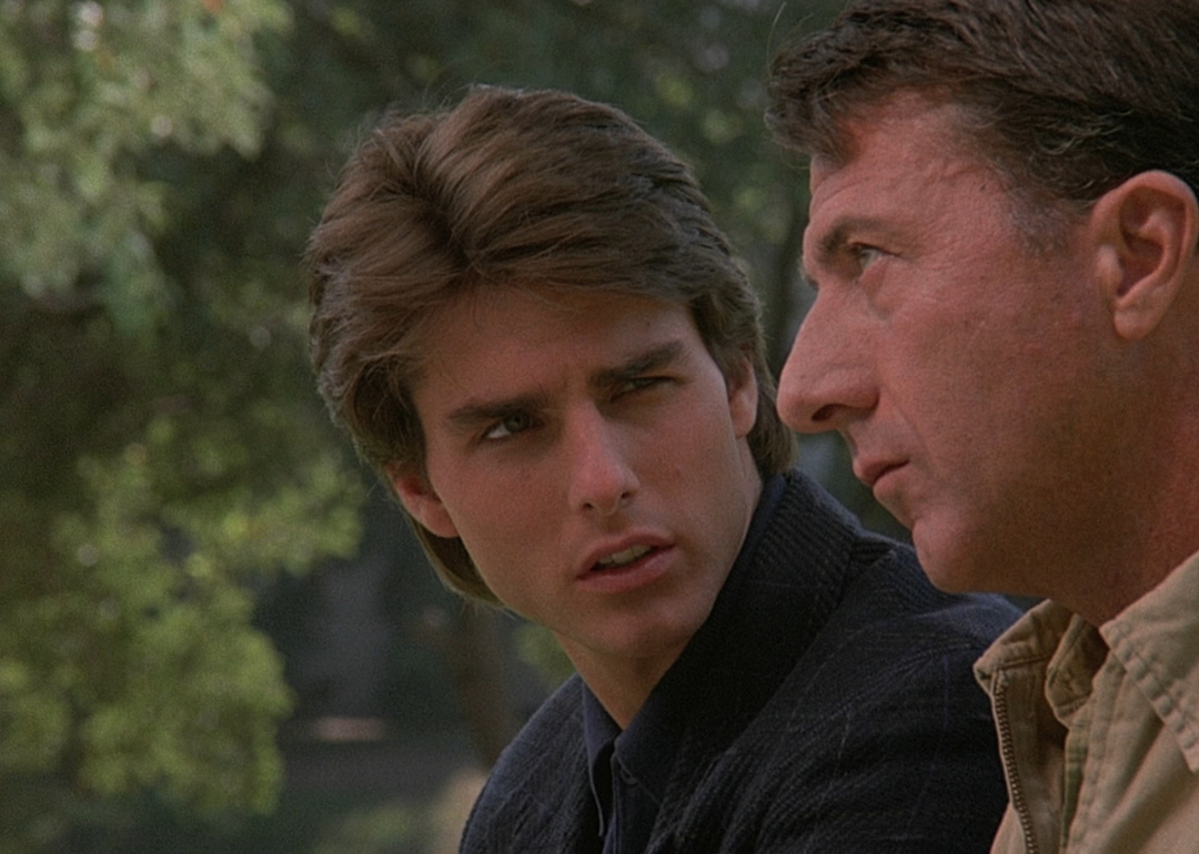 Tom Cruise stares at Dustin Hoffman, as he stares off into the distance.
