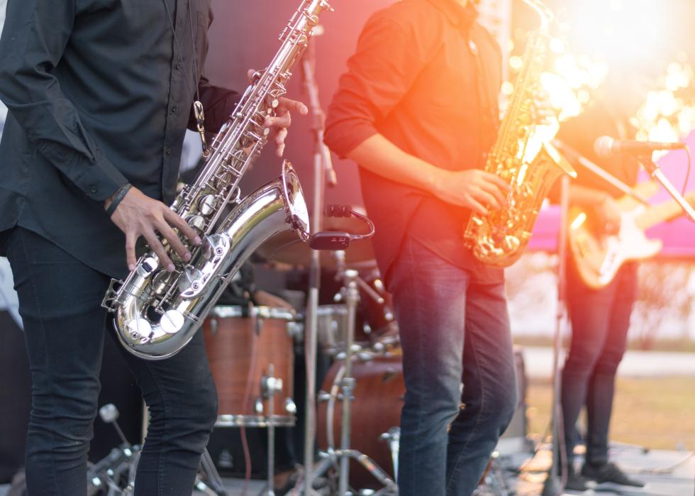 Saxophonist player and band musicians on stage
