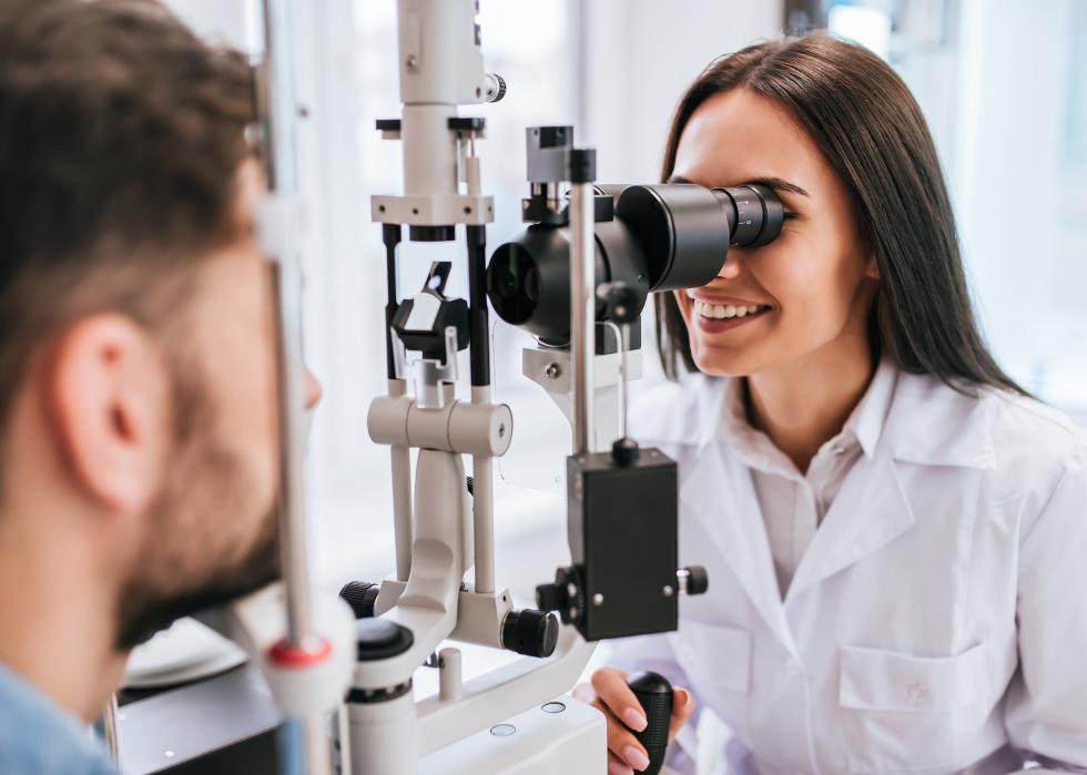 An opthamologist examining a patient.