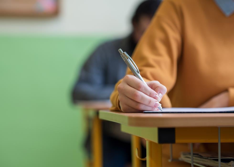 Students taking exam in classroom.