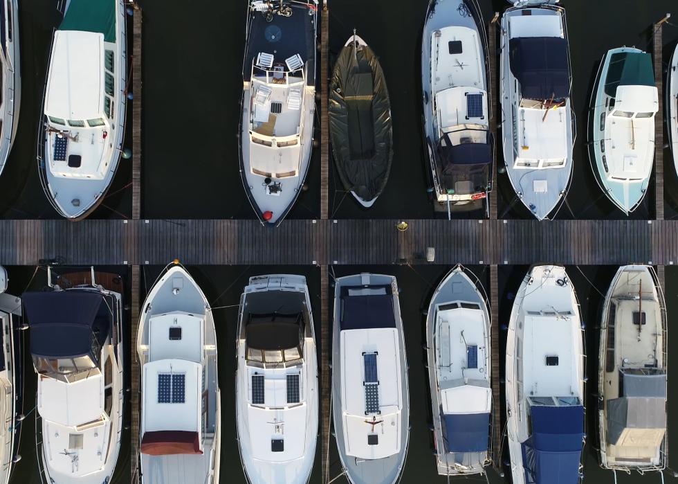 Aerial top picture of a dock basin with moorings and supplies for yachts and small boats.