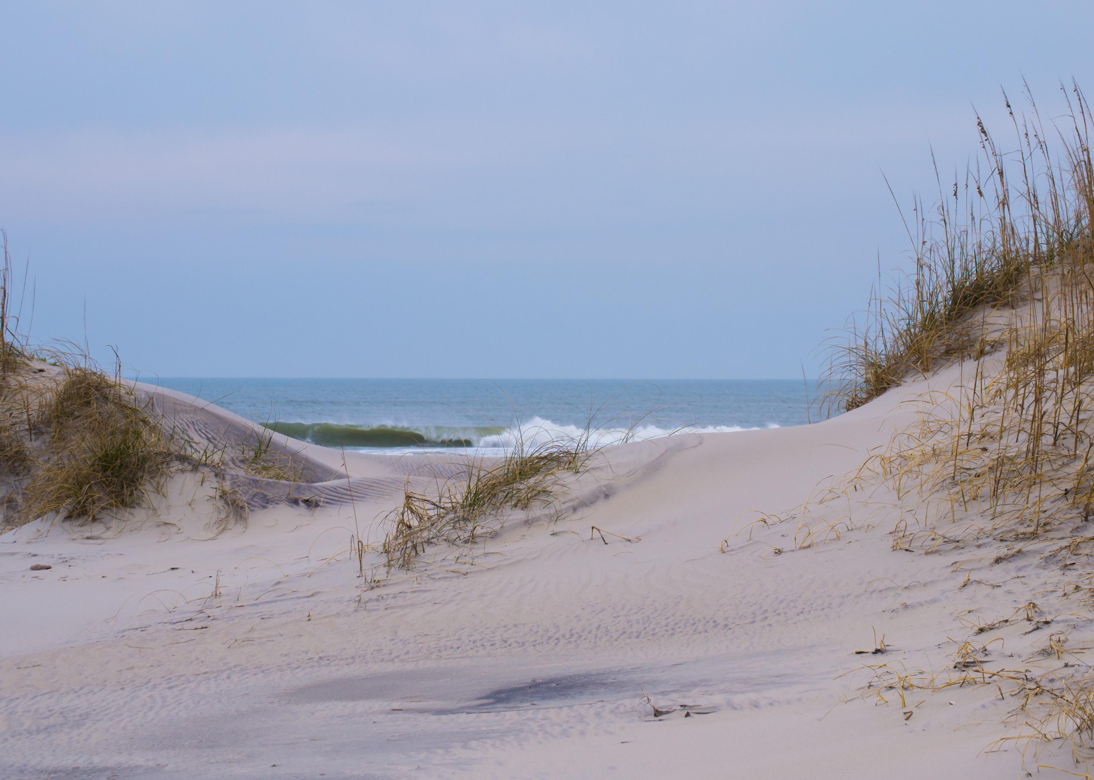 Sand dunes and water on horizon. 