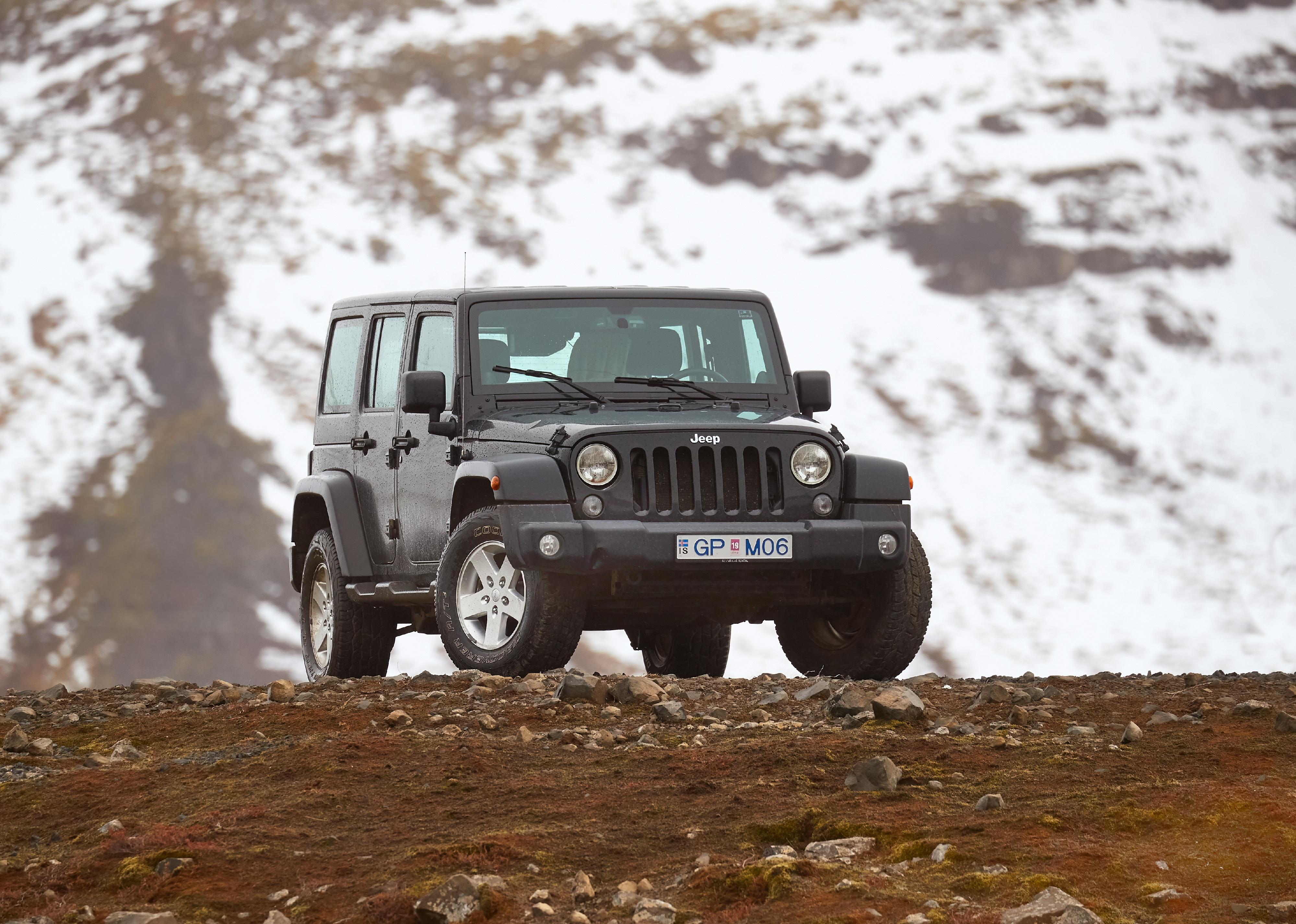 Jeep Wrangler Unlimited four wheel drive vehicle on a mountain landscape.