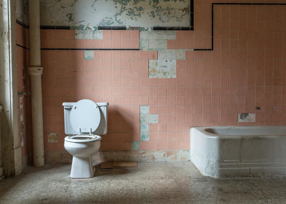 Pink tile and toilet in an old bathroom