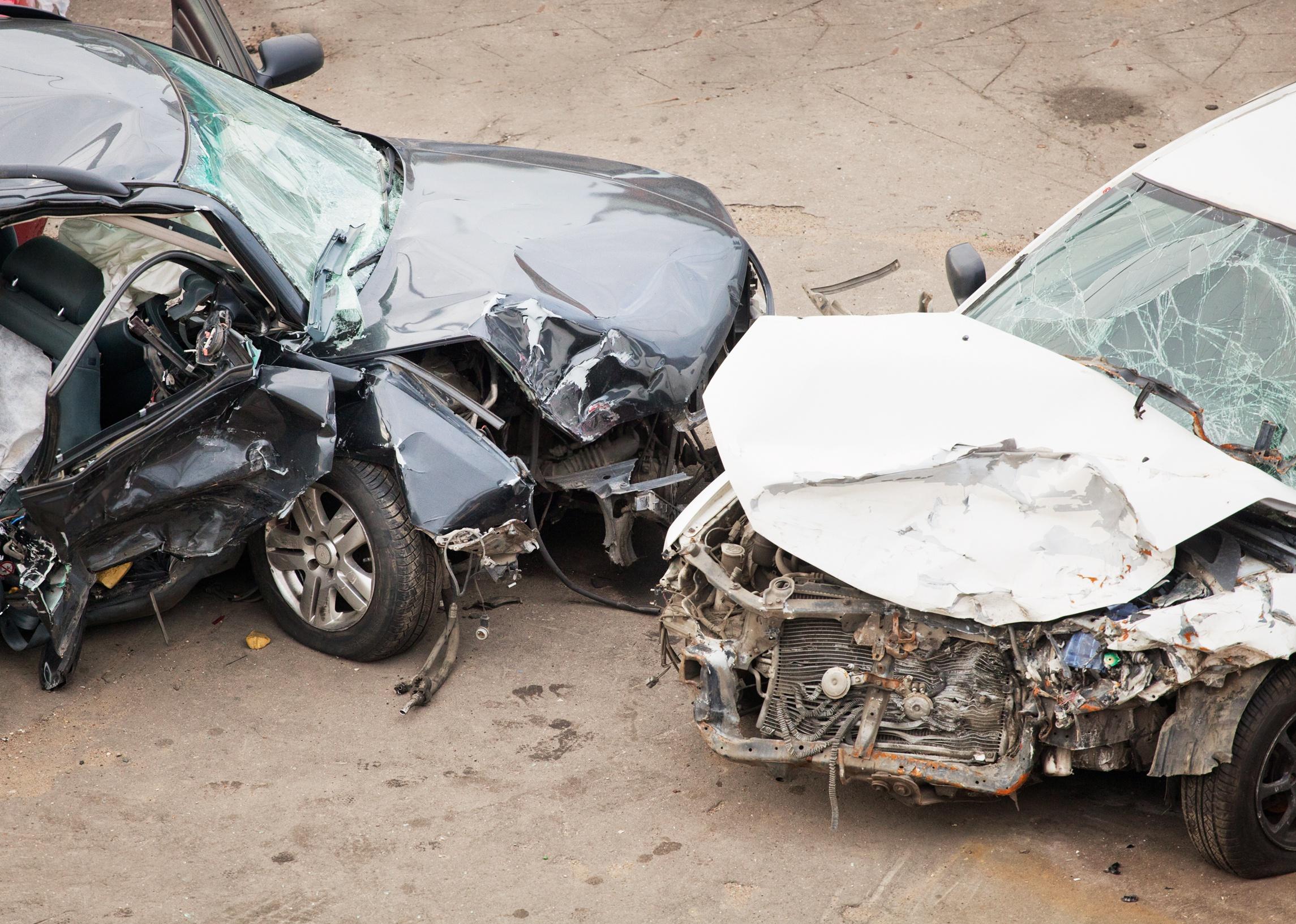 A white and black car pictured after a crash.