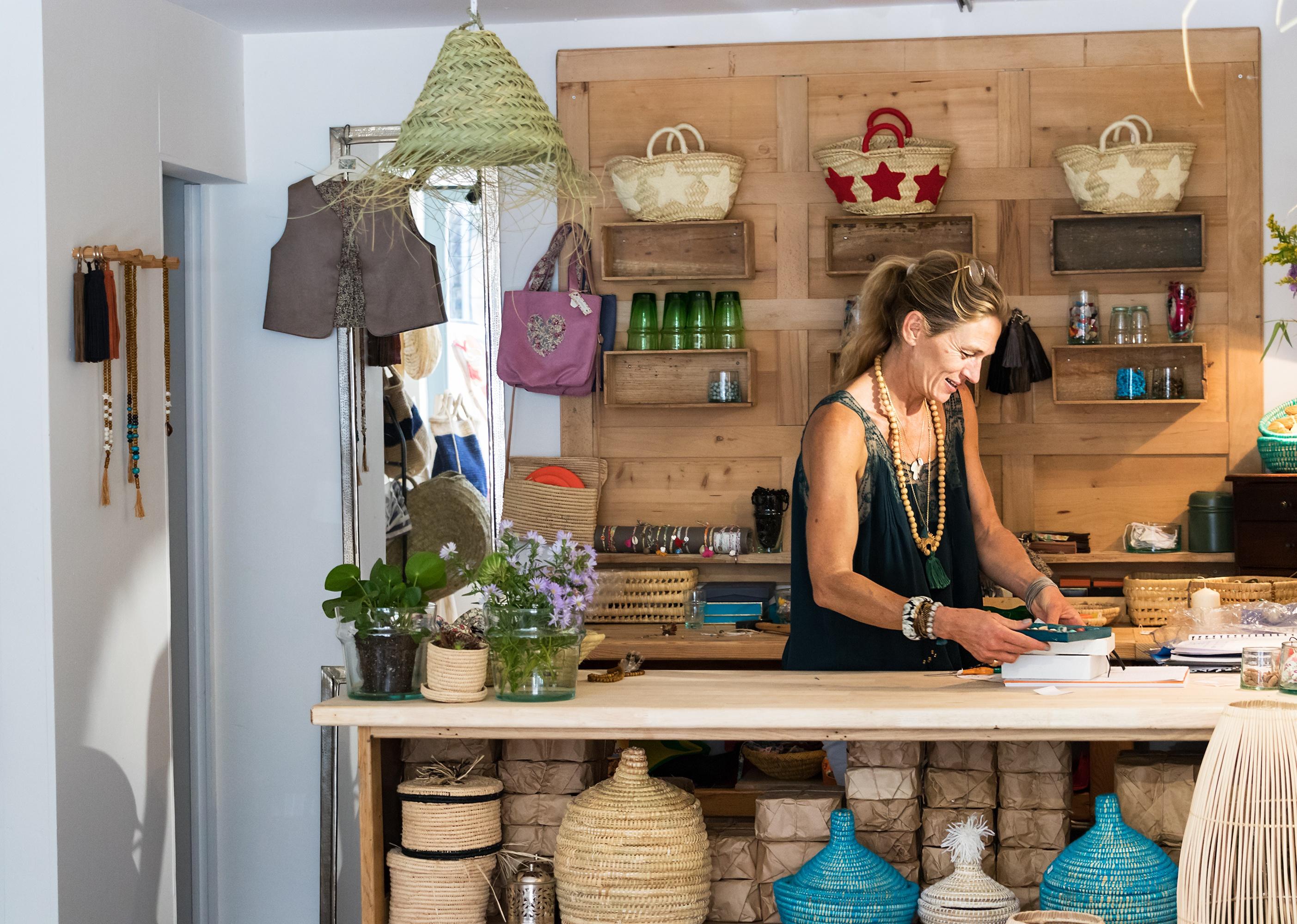 Person working at their handmade gifts store.