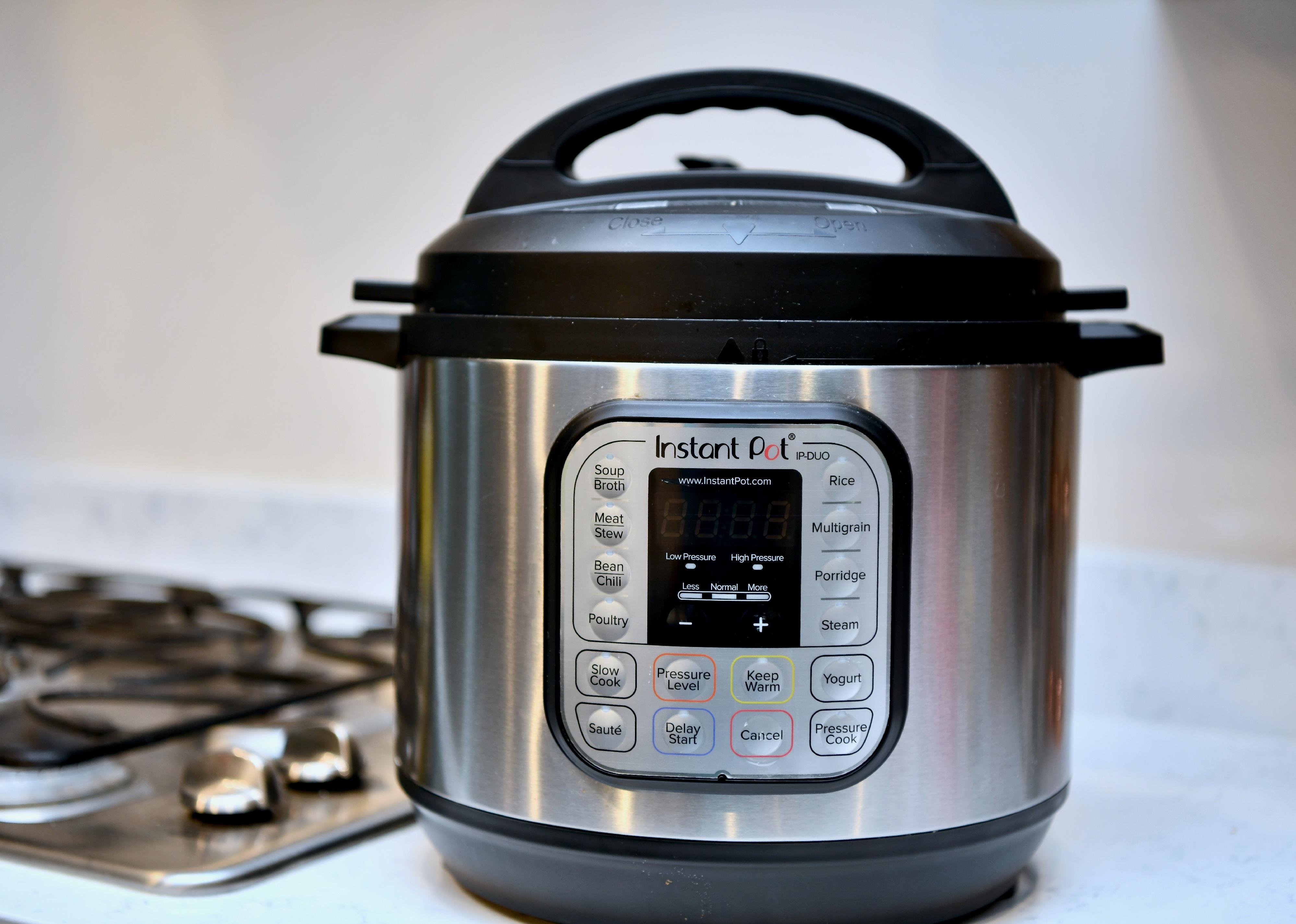 Instant Pot on counter next to stove.