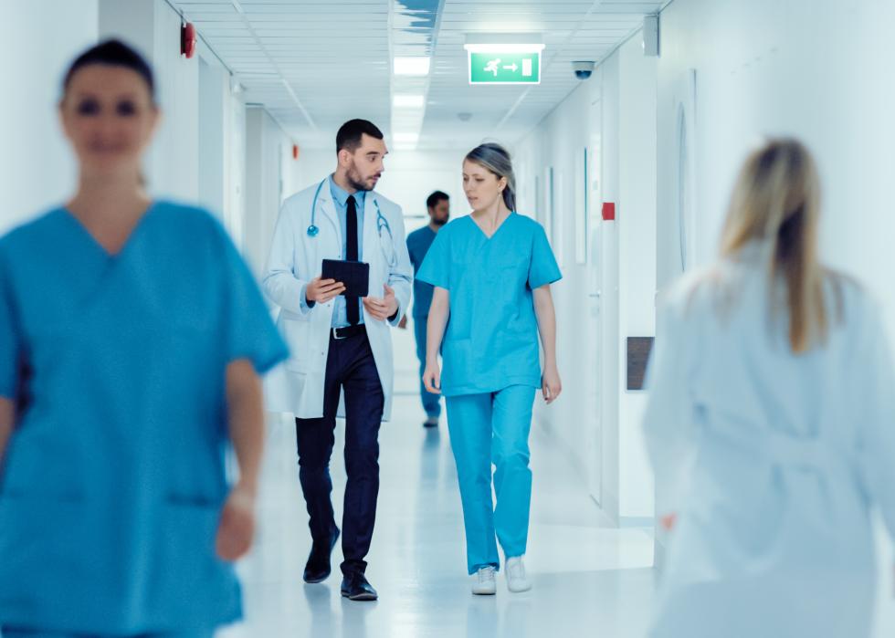 Hospital staff walking in a hallway.