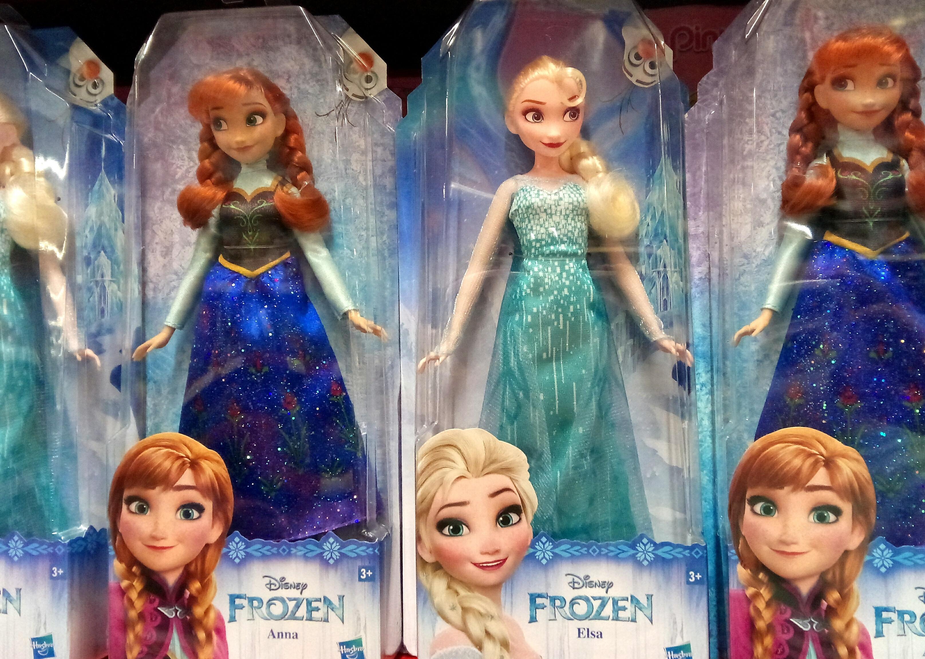 Selection of Disney 'Frozen' Elsa and Anna dolls on display.