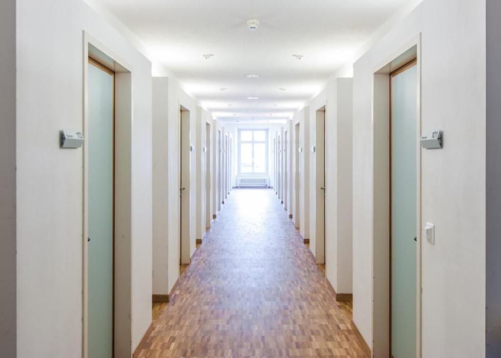 An empty hall lined with doors.