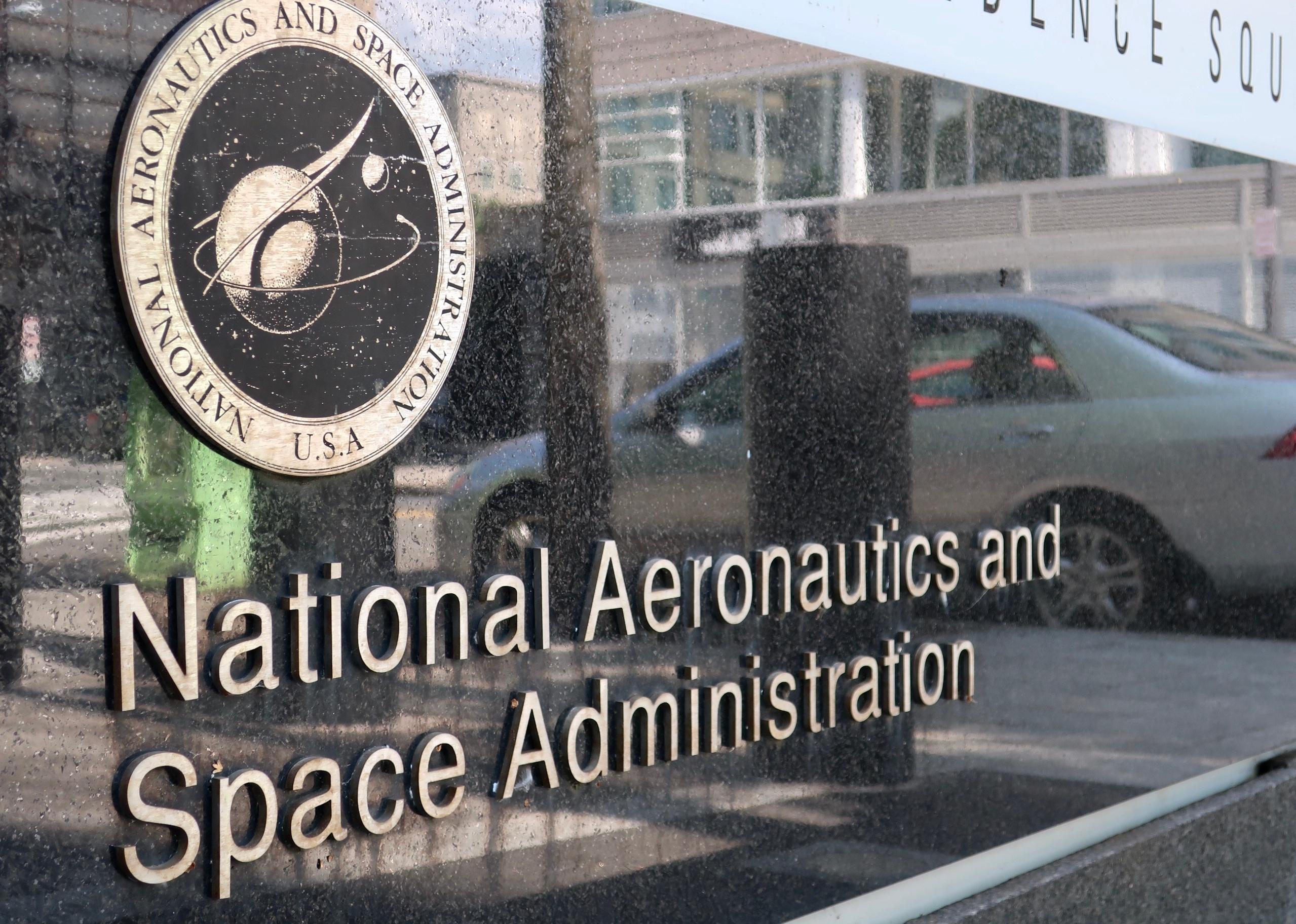 NASA sign in front of headquarters building.