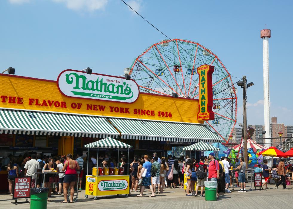 Exterior busy view of the original Nathan’s Famous on the Coney Island Boardwalk