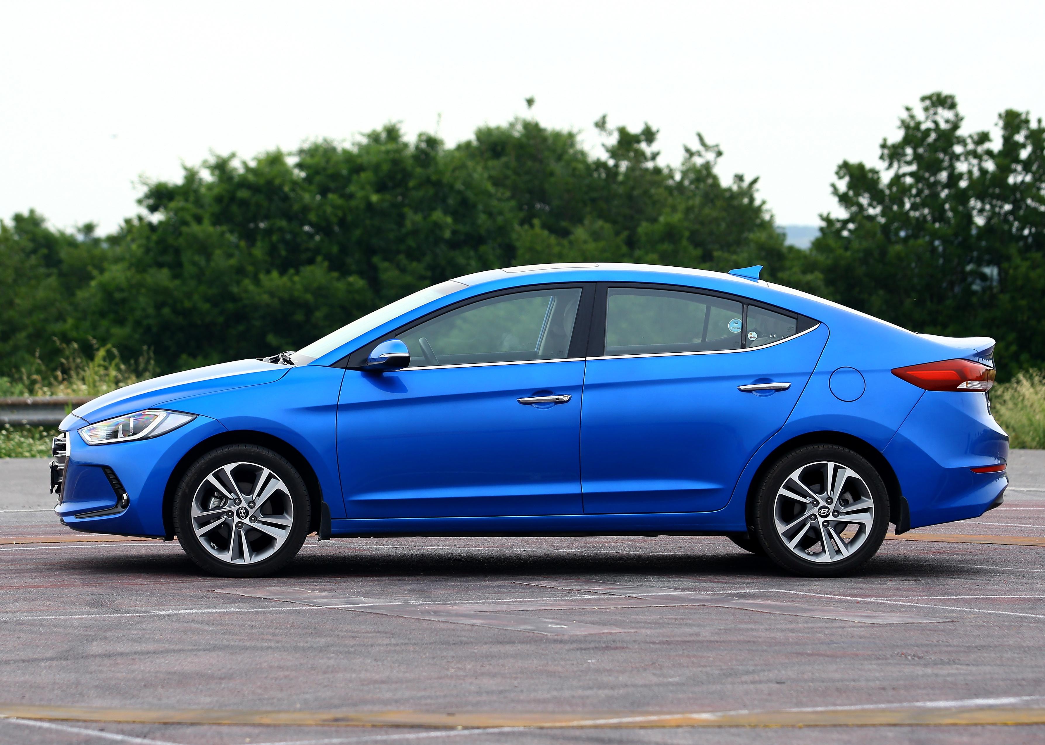 Blue Hyundai Elantra parked on a street.