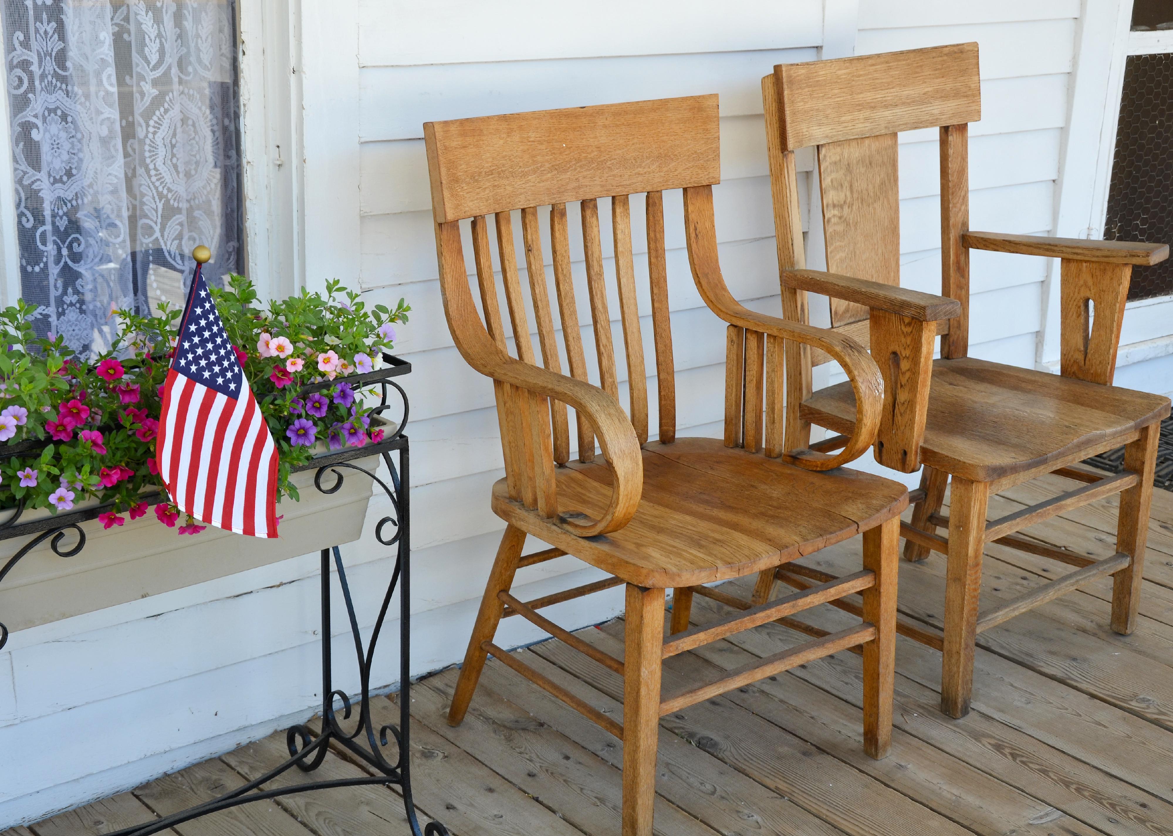 Two wooden chairs on old front porch