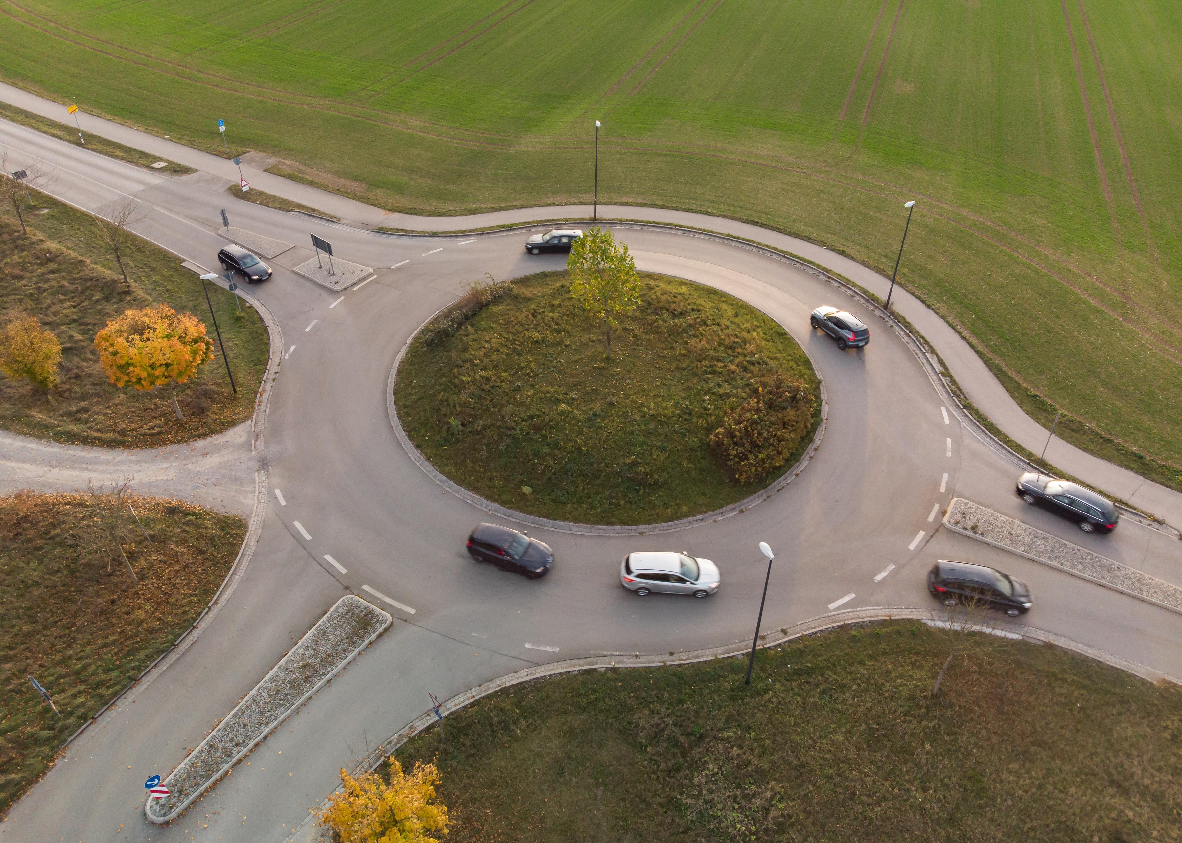 Aerial view of roundabout traffic with car.