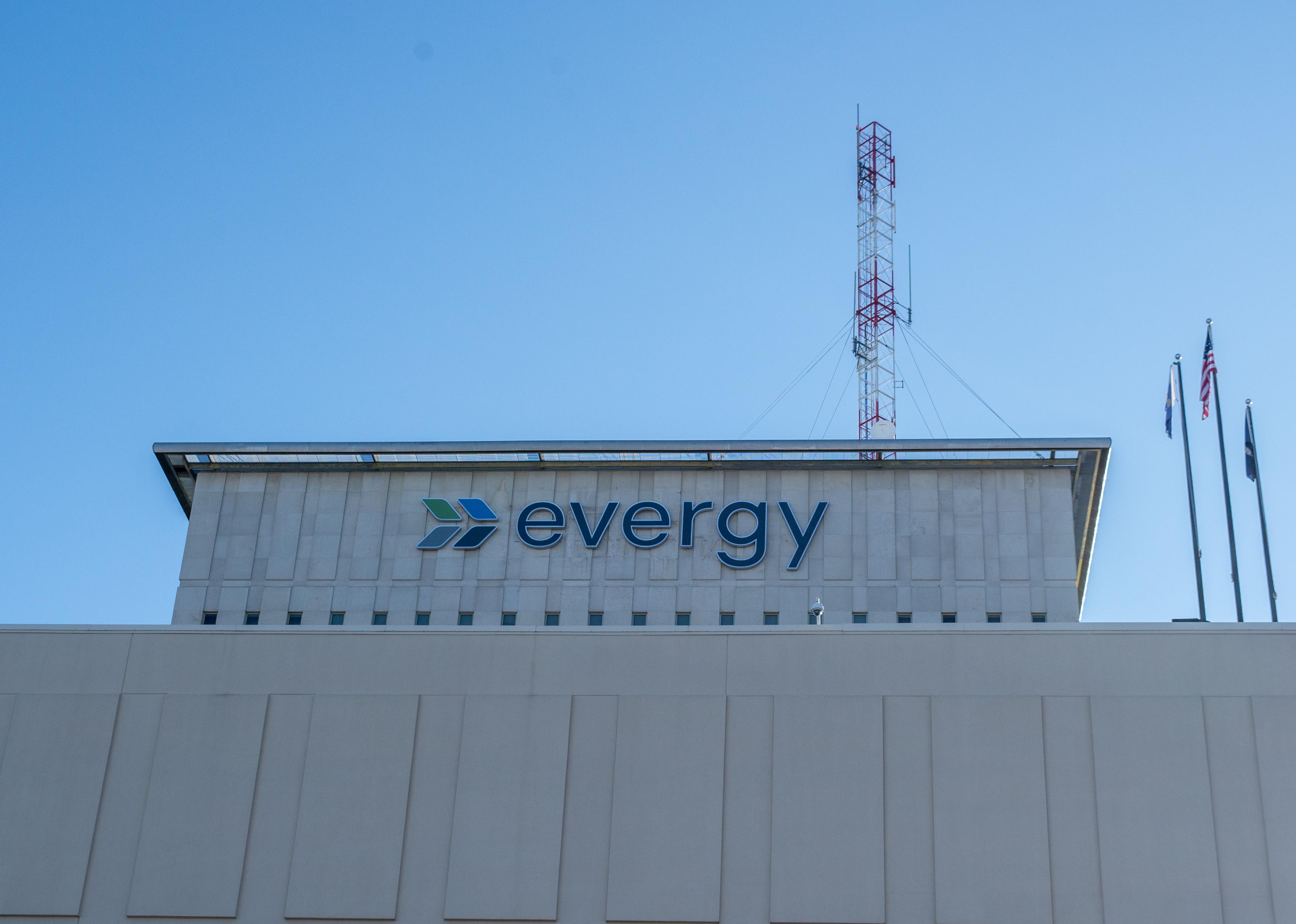 Evergy sign on the side of a building with radio antennas on top.