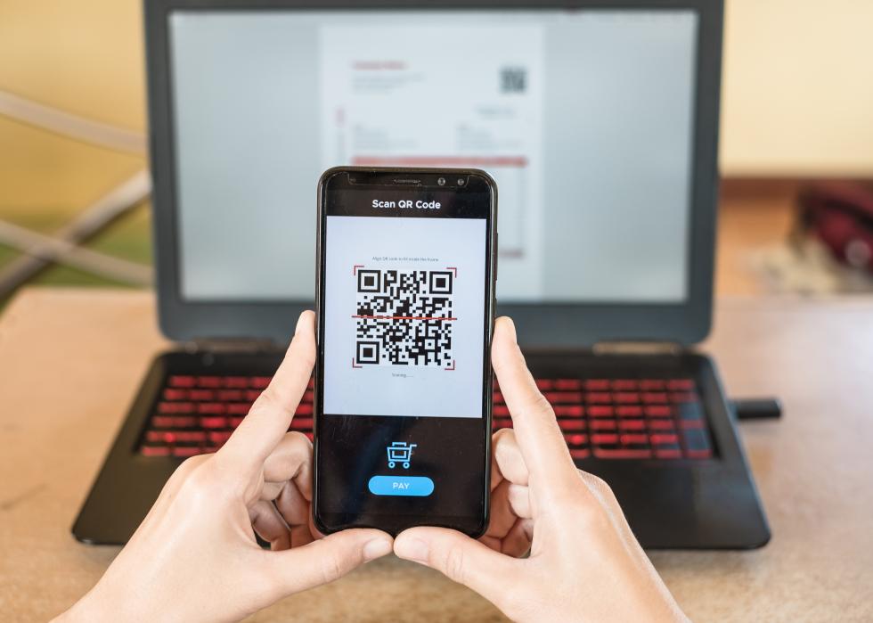 Closeup of smartphone making mobile payment via QR code.