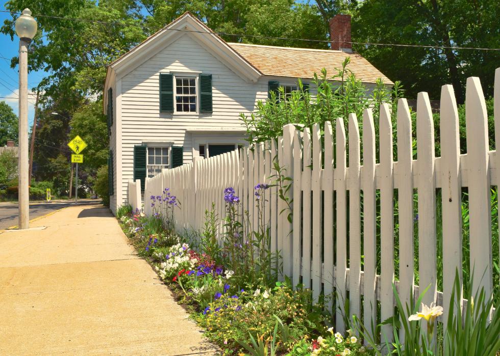 A white fence and colonial home in Lexington, MA