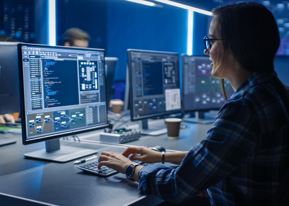 Programmer working on code on a computer.