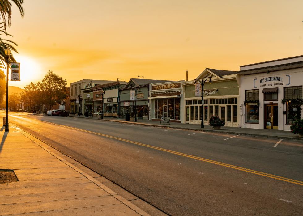 Sunset over an empty road and store fronts